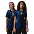 Two children pose in blue and black patterned Brazil soccer jerseys with yellow Jordan and CBF logos against a black background.