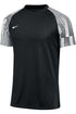 Black Nike short-sleeve athletic shirt with black and white horizontal striped raglan sleeves and a white swoosh logo on the left chest.