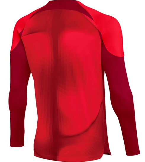 The back view of a long-sleeved athletic jersey featuring two shades of red. The design has dark maroon sleeves and shoulder accents, with a bright crimson main panel showing a subtle, flowing geometric pattern.