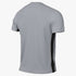 Back view of a grey short-sleeved athletic shirt with a perforated mesh texture and a vertical black stripe running down the side.