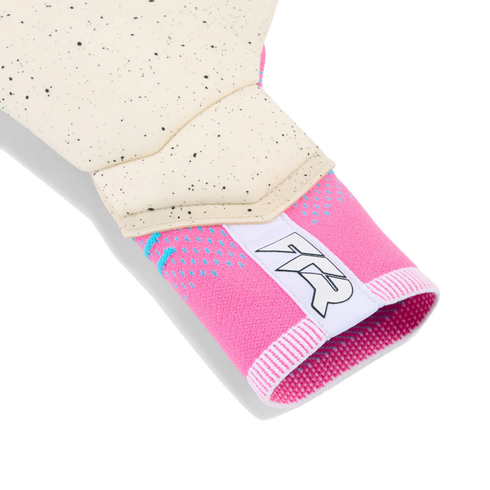 Close-up of a goalie glove showing a pink knit strapless cuff with a white "TR" logo and a cream-colored, black-speckled latex palm.