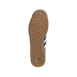A gum rubber Adidas shoe outsole with an intricate tread pattern and a trefoil logo, centered against a solid black background.