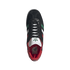Overhead view of a black Adidas sneaker with green, white, and red stripes, a red interior, and a Mexico logo on the insole, set against a black background.