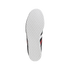 Top-down view of a white sneaker sole with a hexagonal grip pattern. Parts of the black upper with red and white stripes are visible against a solid black background.