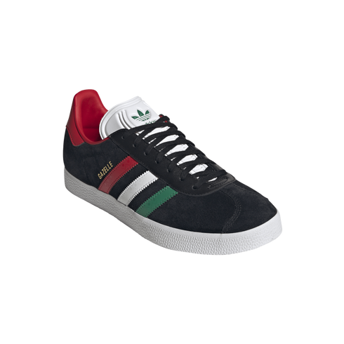 A black suede Adidas Gazelle sneaker with red, white, and green stripes and a textured white sole, isolated against a black background.