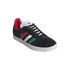 A black suede Adidas Gazelle sneaker with red, white, and green stripes and a textured white sole, isolated against a black background.