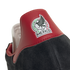 Close-up of the heel of a black suede shoe with a red leather tab featuring the embroidered Mexico national football team logo.