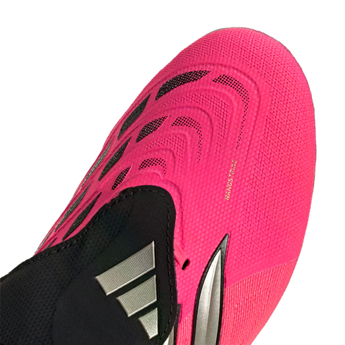 Close-up of a bright pink Adidas soccer cleat showing textured patterns, black accents, a silver logo, and 'NANOSTRIKE' lettering on the forefoot.
