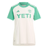 White Austin FC soccer jersey with light green sleeves and collar, featuring a large green Yeti sponsor logo on the chest and Adidas branding.