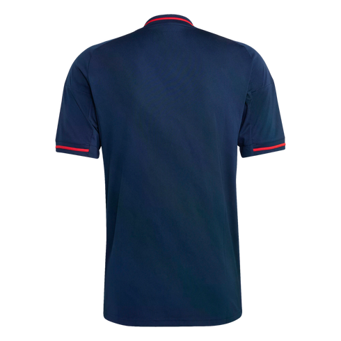 Back view of a navy blue short-sleeved shirt featuring thin red accent stripes on the collar and sleeve cuffs, set against a solid black background.