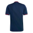 Back view of a navy blue short-sleeved shirt featuring thin red accent stripes on the collar and sleeve cuffs, set against a solid black background.