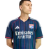 Male model wearing a navy blue Olympique Lyonnais soccer jersey with thin red stripes and white Adidas and Emirates logos.