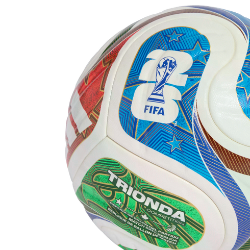 Close-up of a white soccer ball featuring colorful graphics, including a blue FIFA 26 logo with the World Cup trophy and a green "TRIONDA COMPETITION" patch.