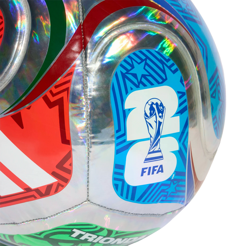 Close-up of a holographic silver soccer ball featuring colorful red, green, and blue geometric patterns and the FIFA World Cup 2026 logo.
