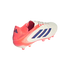 White and bright pink Adidas Copa soccer cleat featuring three navy blue stripes, shown from a side-rear perspective against a solid black background.