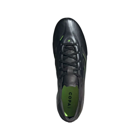 Top-down view of a black Adidas Copa Pure II soccer cleat with neon green accents and insole against a black background.