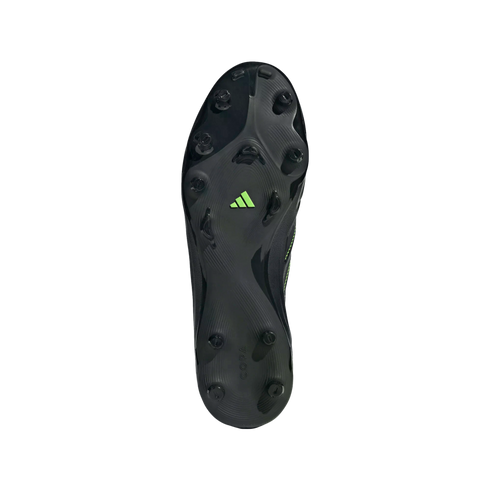 Bottom view of a black Adidas Copa soccer cleat soleplate, featuring black studs, a lime green logo, and a textured pattern.