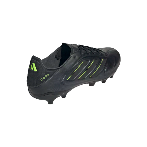 A black Adidas Copa soccer cleat featuring neon green accents on its side stripes and heel logo, shown from a rear-side angle against a black background.