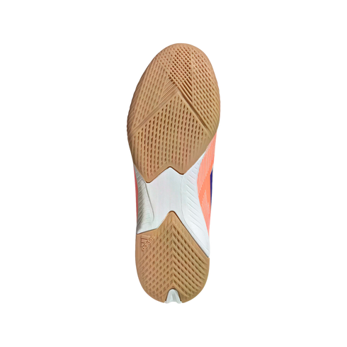The textured tan gum rubber outsole of an Adidas indoor sports shoe, showing intricate grip patterns and white and peach accents on the midfoot.