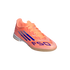 A bright orange and coral Adidas F50 indoor soccer shoe with blue stripes and logo on a solid black background.