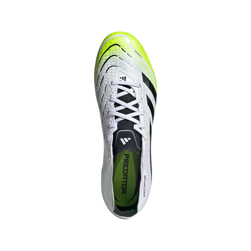 Top-down view of a white Adidas Predator soccer cleat with neon yellow accents and a scaled texture on a black background.