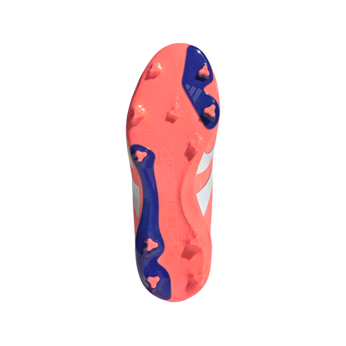 Underside of a coral-pink and blue Adidas Predator soccer cleat with triangular studs and embossed "PREDATOR" text, isolated on a black background.