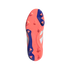 Underside of a coral-pink and blue Adidas Predator soccer cleat with triangular studs and embossed "PREDATOR" text, isolated on a black background.