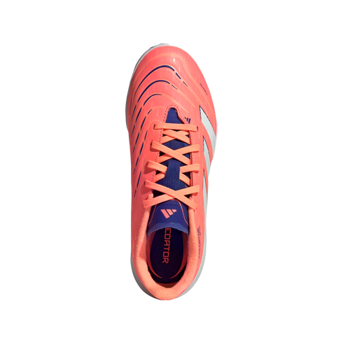 Top-down view of a bright coral Adidas Predator soccer cleat with navy blue and white accents on a solid black background.