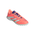 A coral pink Adidas Predator turf soccer shoe with three white stripes and purple accents, angled against a solid black background.