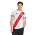 A man wearing a white River Plate football jersey with a red diagonal sash and black shorts against a plain white background.