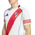 A person wears a white River Plate football jersey featuring a red diagonal sash, three red stripes on the sleeves, and the Adidas logo. Set against a plain white background.