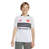 A smiling young boy in a white D.C. United soccer jersey and grey pants against a black background.