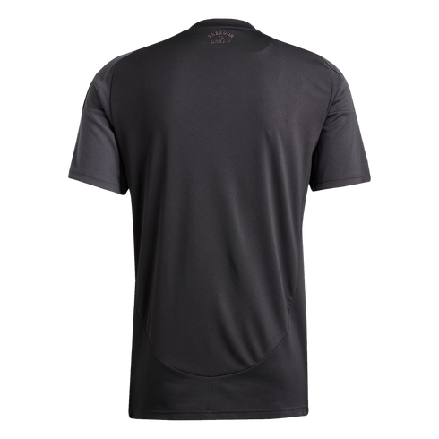Back view of a black short-sleeved t-shirt with small pink "FREEDOM TO DREAM" text on the upper back.