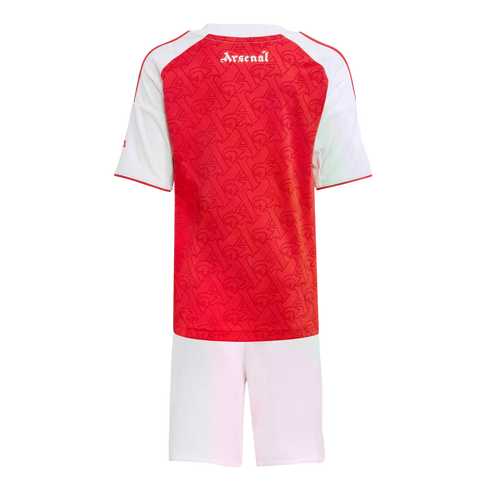 Back view of an Arsenal kids' football kit featuring a red patterned jersey with white sleeves and "Arsenal" script on the upper back, paired with white shorts.