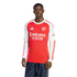 A man models a long-sleeved red and white Arsenal FC soccer jersey with the Emirates sponsor logo and dark blue athletic pants against a plain white background.