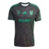 A black soccer jersey with a dark gray hexagonal pattern and bright green accents. It features the Cemex logo on the chest and the Tigres UANL club crest.