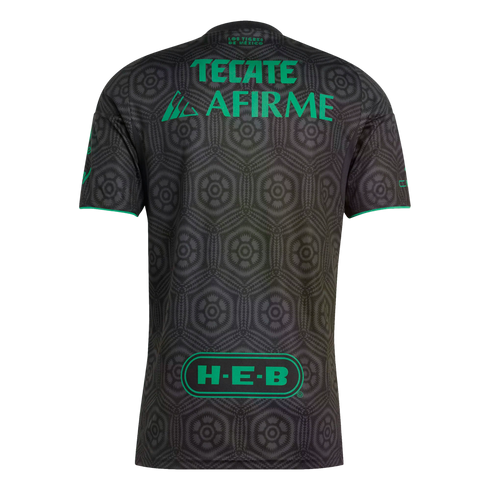 Back view of a gray soccer jersey with a black hexagonal pattern and bright green sponsor logos (Tecate, Afirme, and H-E-B) on the center and bottom.