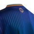Close-up of the back neck of a blue pinstriped jersey featuring an orange circular logo and a green and orange striped collar.