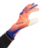 An orange and blue Adidas Predator goalkeeper glove worn on a hand, reaching out against a black background.