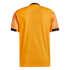 Back view of a bright orange sports jersey with patterned sleeves and black trim at the neck and cuffs, isolated against a black background.