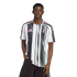 A man wearing a black and white striped Juventus soccer jersey with pink accents, standing against a white background.