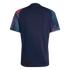 Back view of a navy blue short-sleeved jersey with red and blue abstract patterned raglan sleeves against a black background.