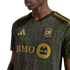 A person wearing a black and gold LAFC soccer jersey with an intricate geometric pattern. Features the gold Adidas logo, team crest, and BMO sponsor logo.