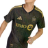 A person wears a black and gold Los Angeles FC soccer jersey featuring an Art Deco geometric pattern, the BMO sponsor logo, and the team crest.