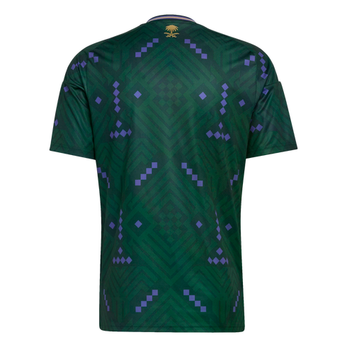 Back of a green Saudi Arabia soccer jersey featuring a purple geometric pattern and a small gold national emblem below the collar.