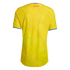 Back view of a yellow Colombia soccer jersey with a tone-on-tone butterfly pattern, red "COLOMBIA" text at the neck, and blue-and-red trim on the collar and sleeves.