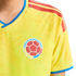 Yellow Colombian national soccer jersey with blue trim and red shoulder stripes, featuring the official federation crest on the chest.