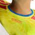 Close-up of the back neckline of a yellow Colombia soccer jersey, featuring red "COLOMBIA" lettering and a blue-trimmed collar.