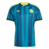 Teal and blue Colombia national soccer jersey with a repeating dark blue wave pattern, yellow trim, and the team's crest.