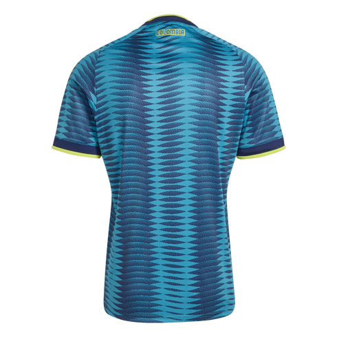Back of a teal and blue Colombia soccer jersey with a wavy geometric pattern, neon yellow trim, and 'COLOMBIA' printed on the upper back.